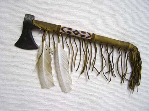 Native American Indian Warrior Tomahawk: Native American Indian Warrior Tomahawk, measures 17" L. Features antiqued finish leather and beaded detailes with a trimmed leather fringe.