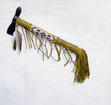 Native American Indian Warrior Tomahawk: Native American Indian Warrior Tomahawk, measures 14.5" L. Features antiqued finish leather and beaded details with a trimmed leather fringe.