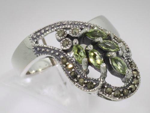 Art Deco Design Marcasite & Peridot Ring: Art Deco Design Marcasite & Peridot Ring, size 7. Features 5 Marquise cut Peridot stones surrounded by marcasites, crafted from fine sterling silver. 0.30 ctw.