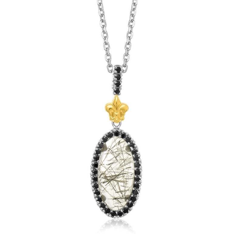 Oval Rutilated Quartz & Black Spinel Pendant: Oval shape pendant features a rutilated quartz surrounded by black spinel accents. Embellished with an upper fleur-de-lis element, this is crafted in 18K yellow gold and sterling silver. measures appr