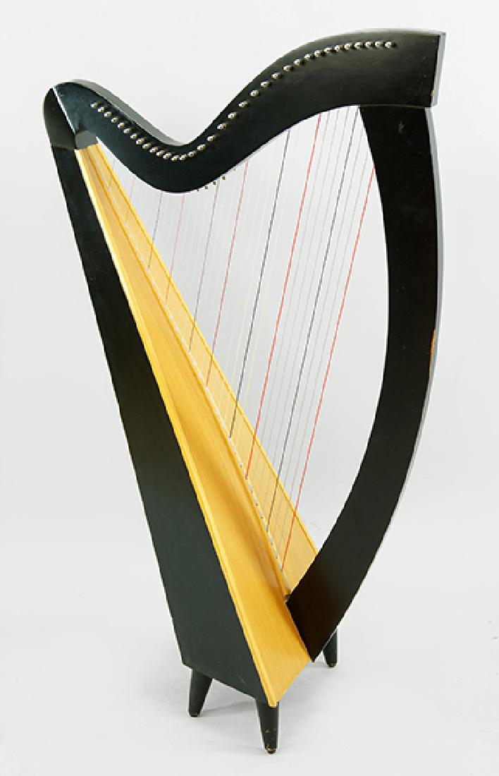 A Lyon & Healey 'Folk' Harp.: A Lyon & Healey 'Folk' Harp. Ebonized case with a birch and spruce soundboard, bearing a metal maker's tag 'The Folk Harp, 1277, Lyon & Healy Harps, Chicago'. Together with padded case and zippered ba