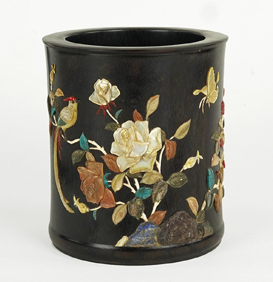 A Chinese Hardwood Brush Pot.: A Chinese Hardwood Brush Pot. Bearing an applied abalone and hardstone decoration of flowers, a bird, and butterfly. With an applied abalone inscription on one side and a seal 6.25" x 5.75"