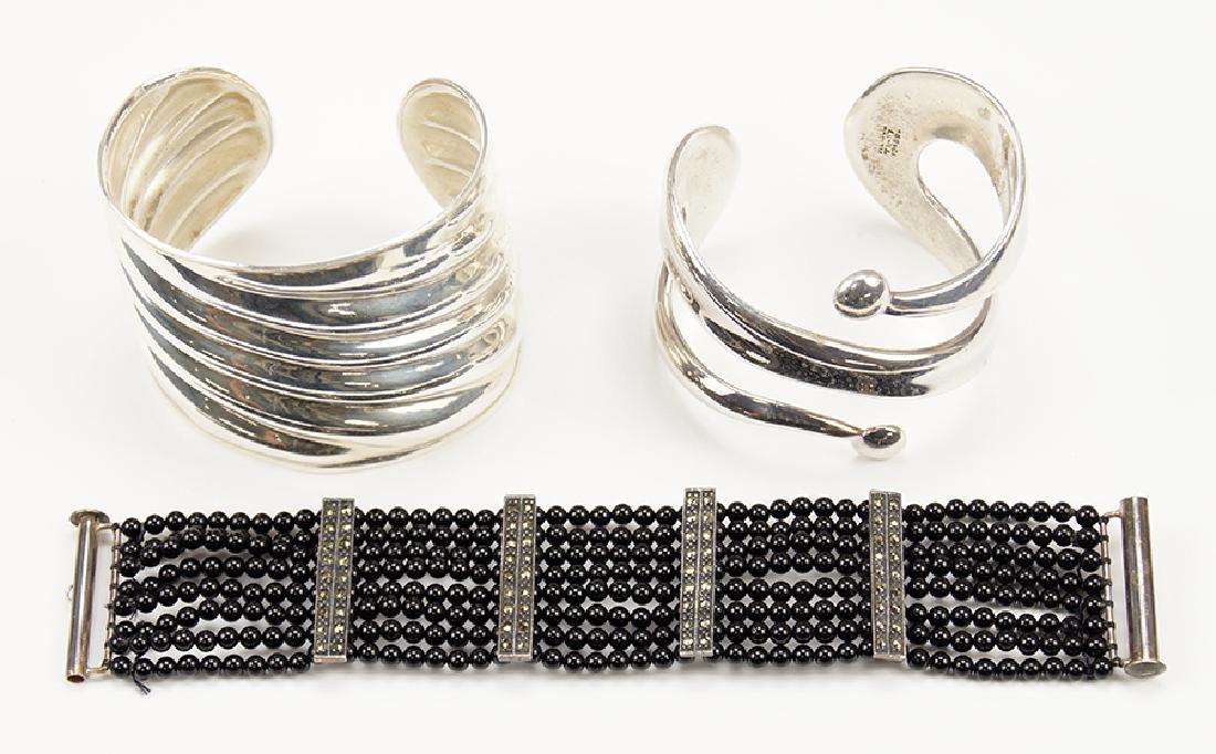 An Onyx and Marcasite Bracelet.: An Onyx and Marcasite Bracelet. Eight row bracelet with sterling silver mounts. Together with two sterling silver cuff bracelets