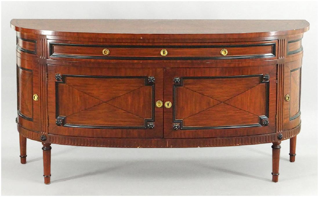 A Trouvailles Sideboard.: A Trouvailles Sideboard. Demilune cabinet with a single drawer above a cabinet, and cabinets on either side 34" x 68.5" x 20.5"