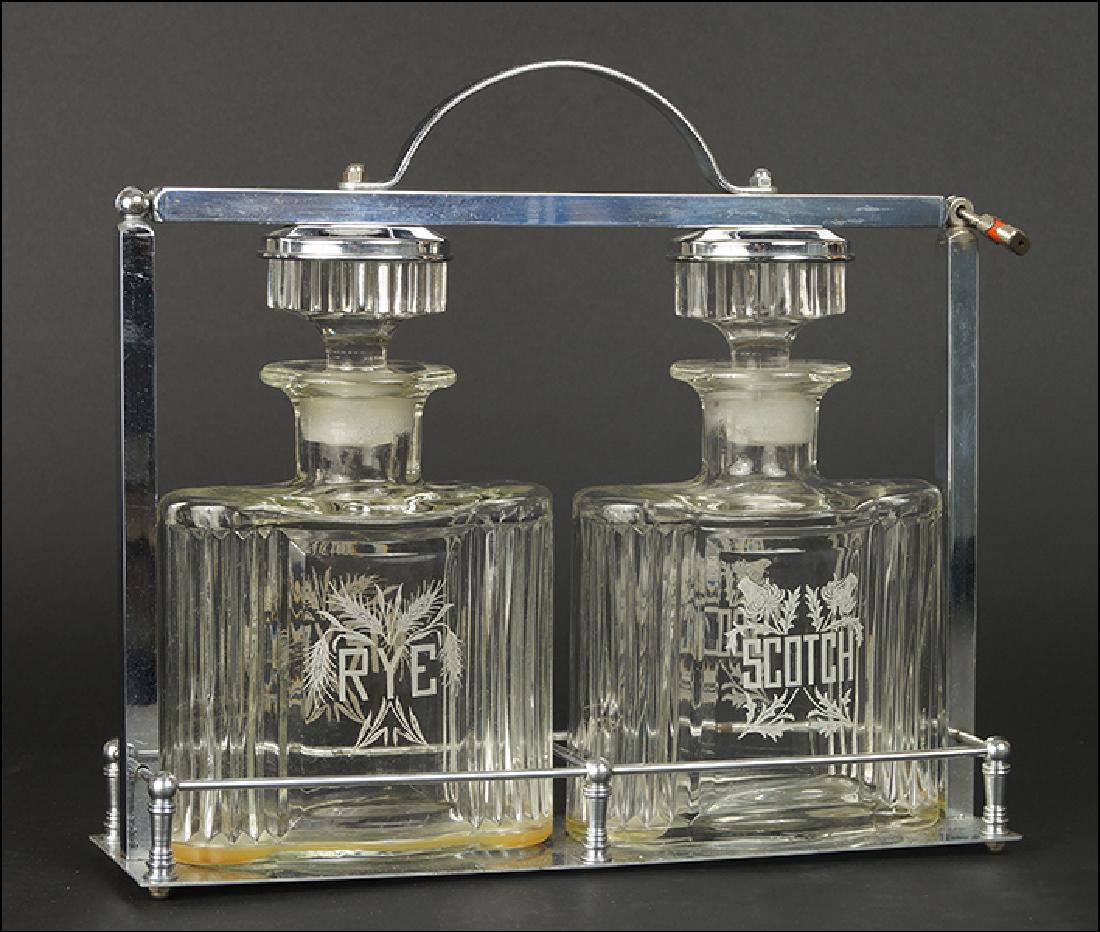 Rye and Scotch Tantalus.: Rye and Scotch Tantalus. Consisting of a stainless locking chrome carrier with acid etched bottles of Rye and Scotch 14" x 12" x 3.5"