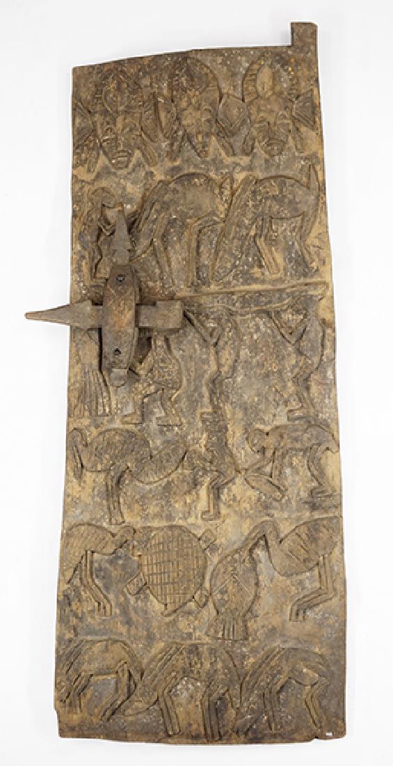 An African Dogon Tribe Carved Granary Door.: An African Dogon Tribe Carved Granary Door. With a carved motif of figures, birds, gazelles, and masks 54" x 22"