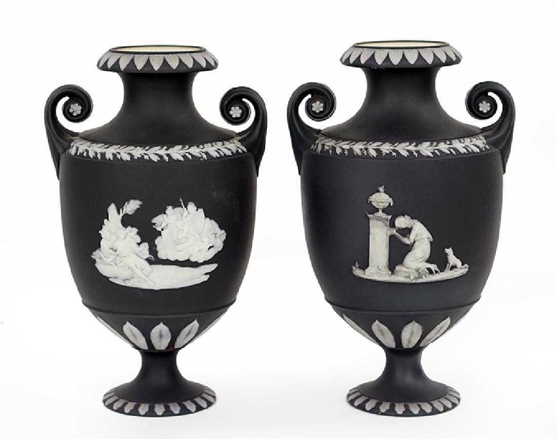 A Pair of Wedgwood Jasperware Vases.: A Pair of Wedgwood Jasperware Vases. Black urn form vases with white decoration Height: 8.5"