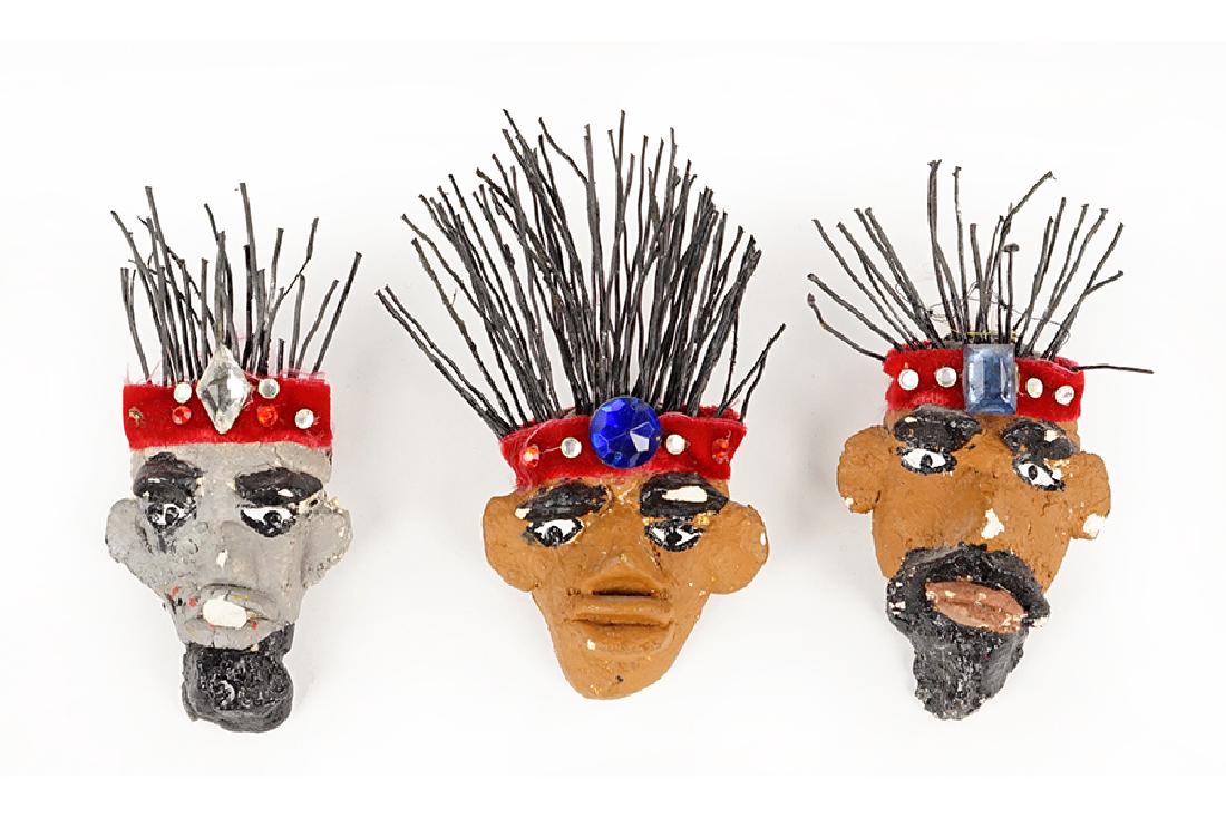 Three Folk Art Pins by Mr. Imagination.: Three Folk Art Pins by Mr. Imagination. Painted ceramic faces with embellishments fitted as pins, each signed and dated '99 Largest: 4.75" x 3"