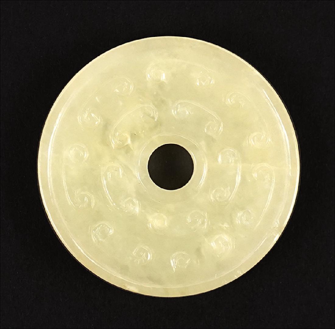 A Han Style Celadon Jade Bi-Disk. (1 of 2)