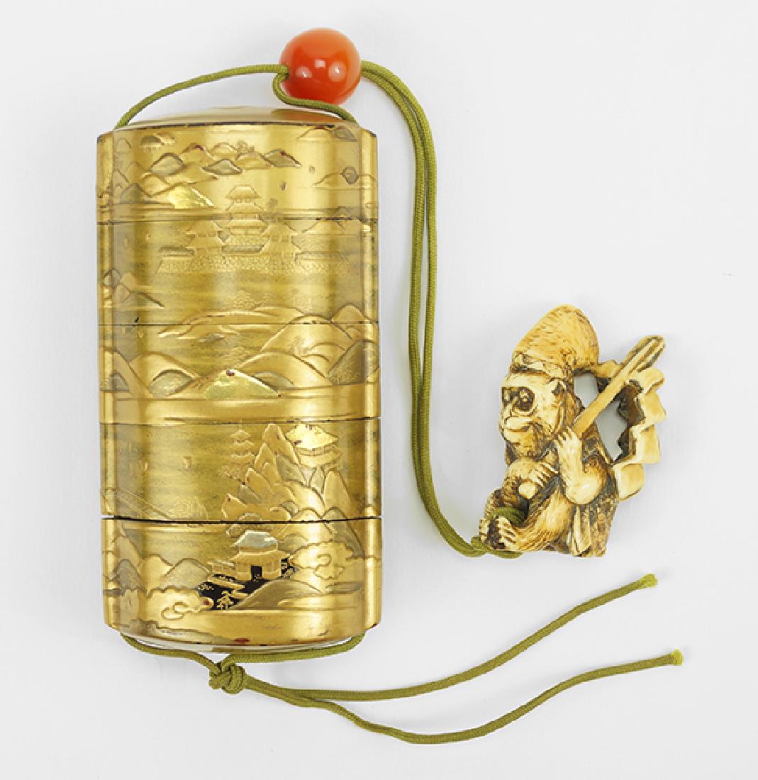 A Japanese Gilt Lacquered Inro.: A Japanese Gilt Lacquered Inro. A five-section gilt lacquered inro decorated with a landscape, with a carnelian bead and a carved bone monkey form netsuke, signed Inro height: 3.5"