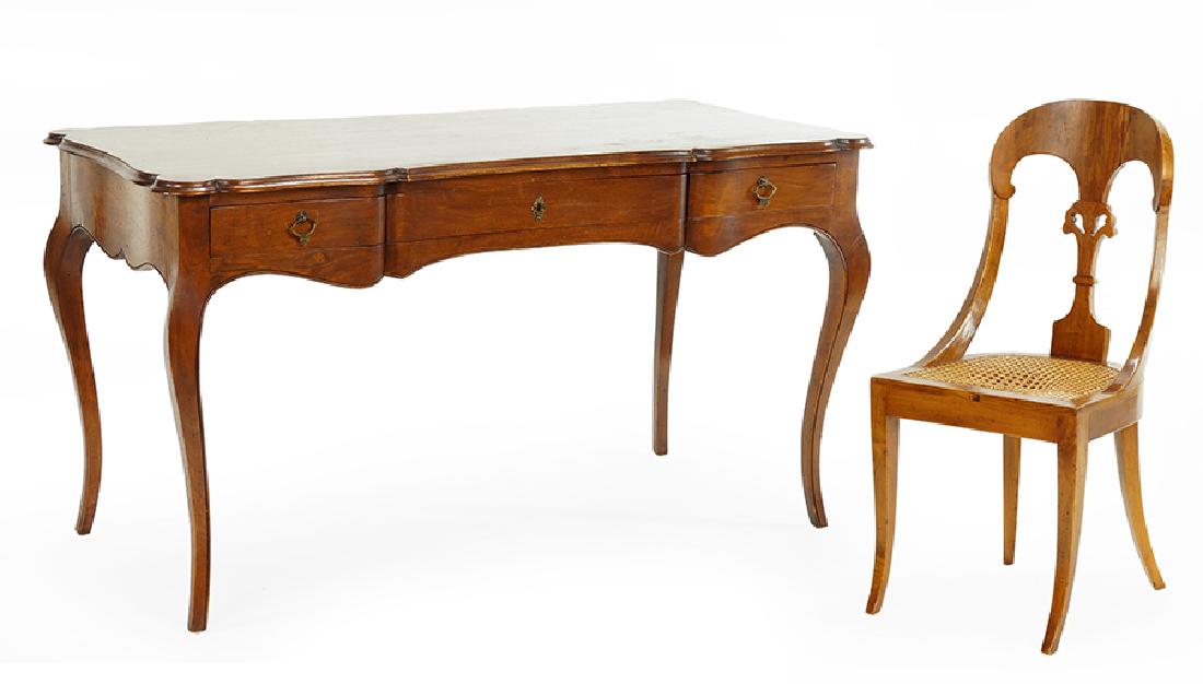 An Italian Mahogany Desk.: An Italian Mahogany Desk. Together with an Italian carved mahogany chair with caned seat (back height: 35.5") 29" x 53" x 26"