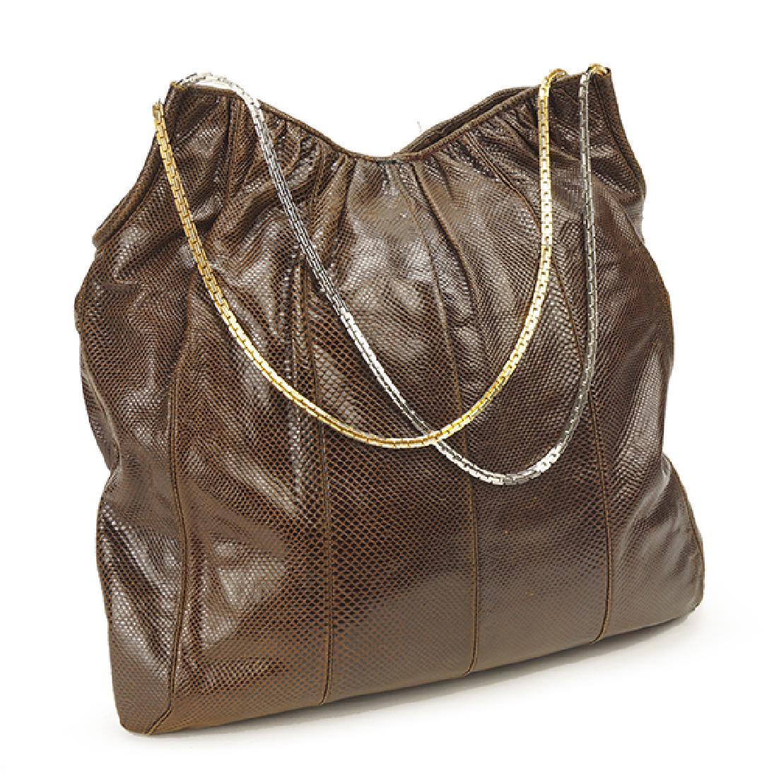 A Judith Leiber Lizard Skin Shoulderbag.: A Judith Leiber Lizard Skin Shoulderbag. Brown lizard skin with silver and goldtoned chain straps. Together with hand mirror 16" x 15" x 2"