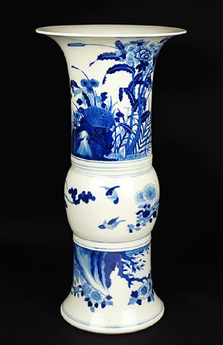 A Chinese Blue and White Porcelain Gu or Beaker Vase.: A Chinese Blue and White Porcelain Gu or Beaker Vase. Decorated with flowers and birds, bearing an underglaze blue double ring on the underside Height: 18.25"