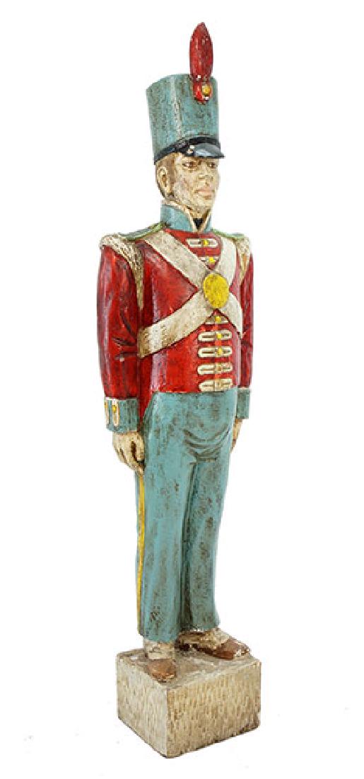 A Carved and Painted Wood Soldier.