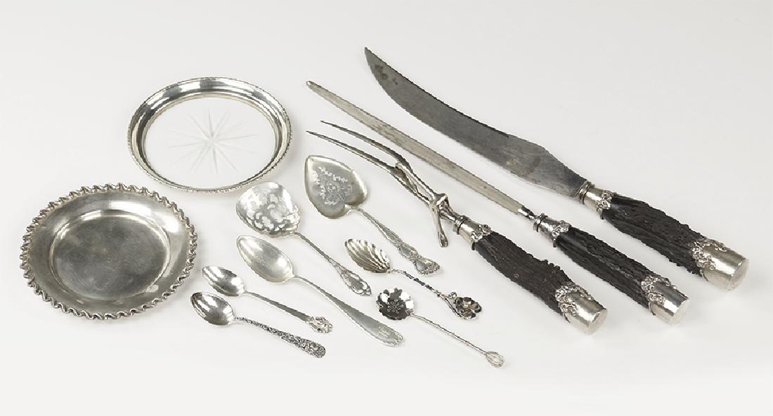 A Sterling Silver Collared Carving Set.: A Sterling Silver Collared Carving Set. Three-piece carving set with faux antler handles. Together with a Wallace sterling silver round dish, a glass and sterling silver wine coaster, and an assortmen