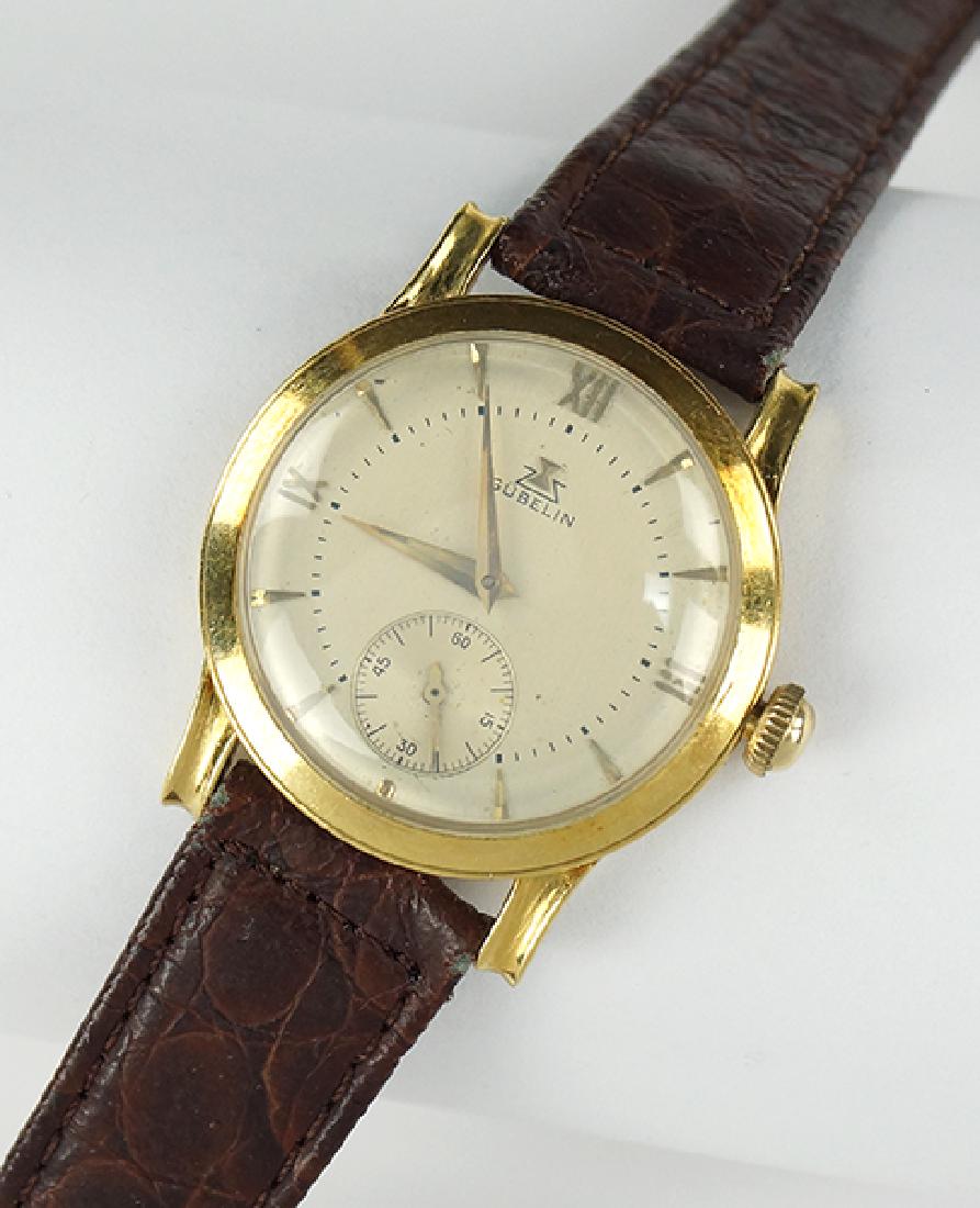 A Gubelin 18 Karat Yellow Gold Watch.: A Gubelin 18 Karat Yellow Gold Watch. Containing a 17 jewel Gubelin movement. Interior of case is stamped "127597". Exterior of case is engraved "M.F August 1949". Bracelet and clasp are a later repla