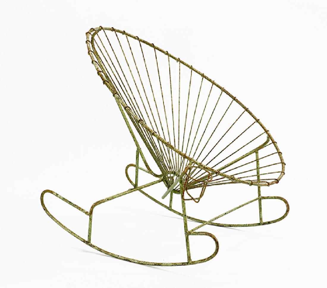 A Patinated Metal Rocking Chair.: A Patinated Metal Rocking Chair. Green painted metal chair with an attached cup holder H: 39" W: 25" D: 37"