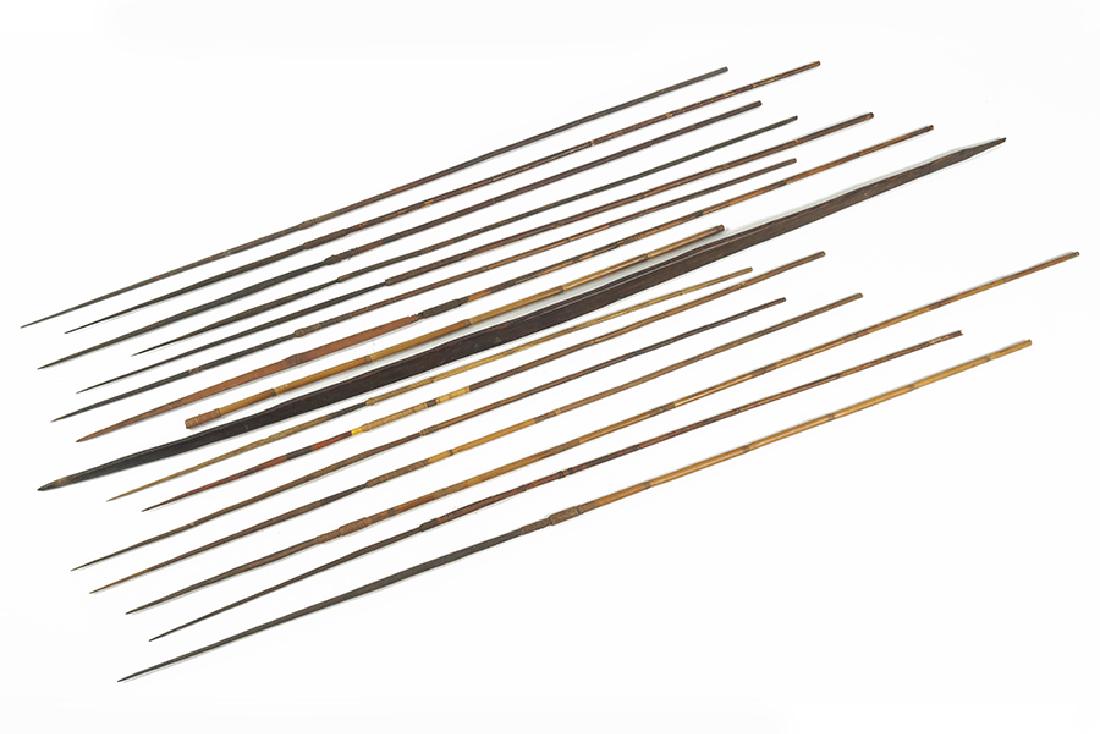 A Papua New Guinea Bow and Arrows.: A Papua New Guinea Bow and Arrows. Comprising a wood bow with fourteen arrows and an additional shaft Bow Length: 62"