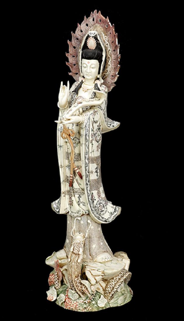A Chinese Ox Bone Tiled Guan Yin Figure.: A Chinese Ox Bone Tiled Guan Yin Figure. Depicted holding an instrument with a dragon at her feet Height: 35"
