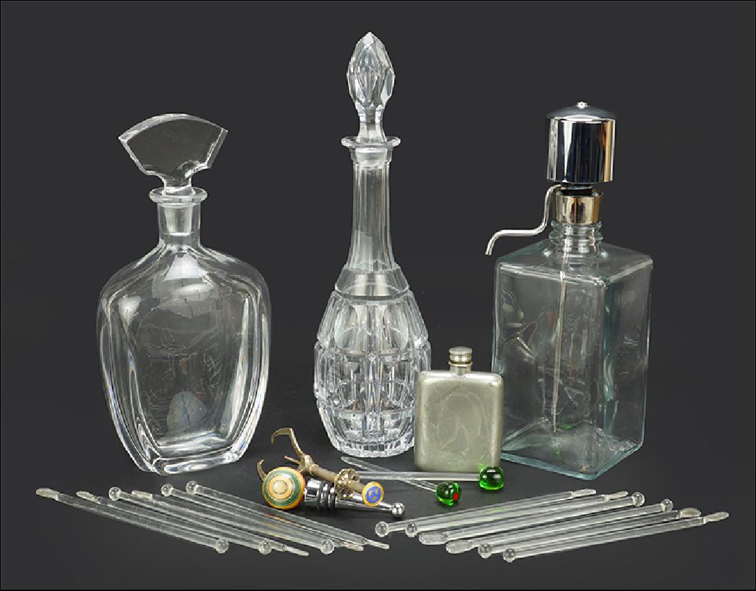 A Collection of Bar Accessories.: A Collection of Bar Accessories. Comprising two crystal decanters (one signed illegibly on the underside), one pressed square glass decanter, one Abercrombie & Fitch "Little Nipper" flask, a pair of g