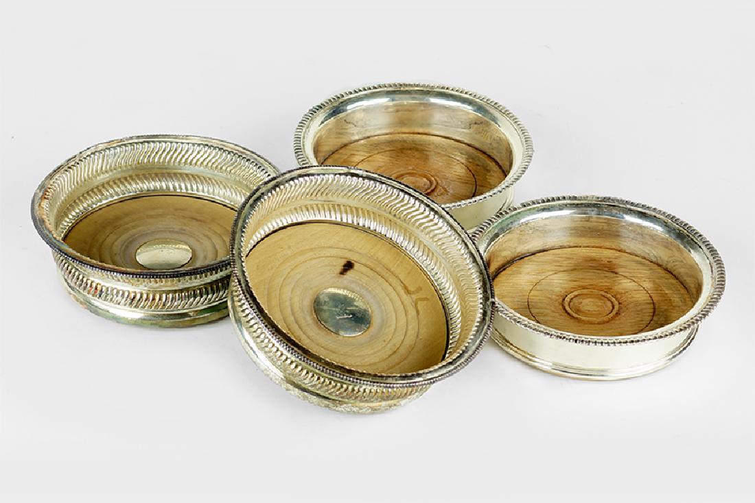 Two Pairs of English Wine Coasters.: Two Pairs of English Wine Coasters. Comprising a pair of coasters with all over gadrooning decoration and a crest engraved at center, and a pair of coasters with fluted edge (1.5" x 6") 2" x 6"