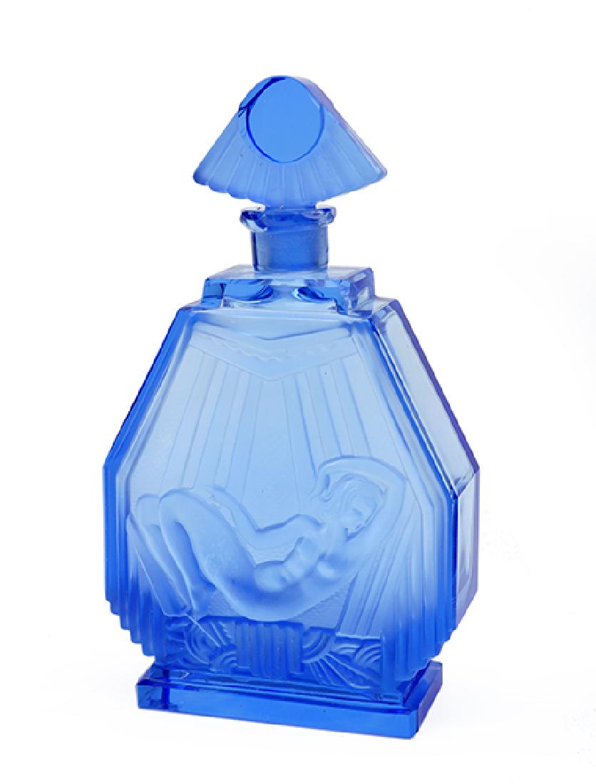 A 1930s Czechoslovakian Blue Crystal Art Deco Perfume: A 1930s Czechoslovakian Blue Crystal Art Deco Perfume Bottle. Clear and frost blue crystal bottle with reclining nude and stylized sun stopper Height: 7.875"