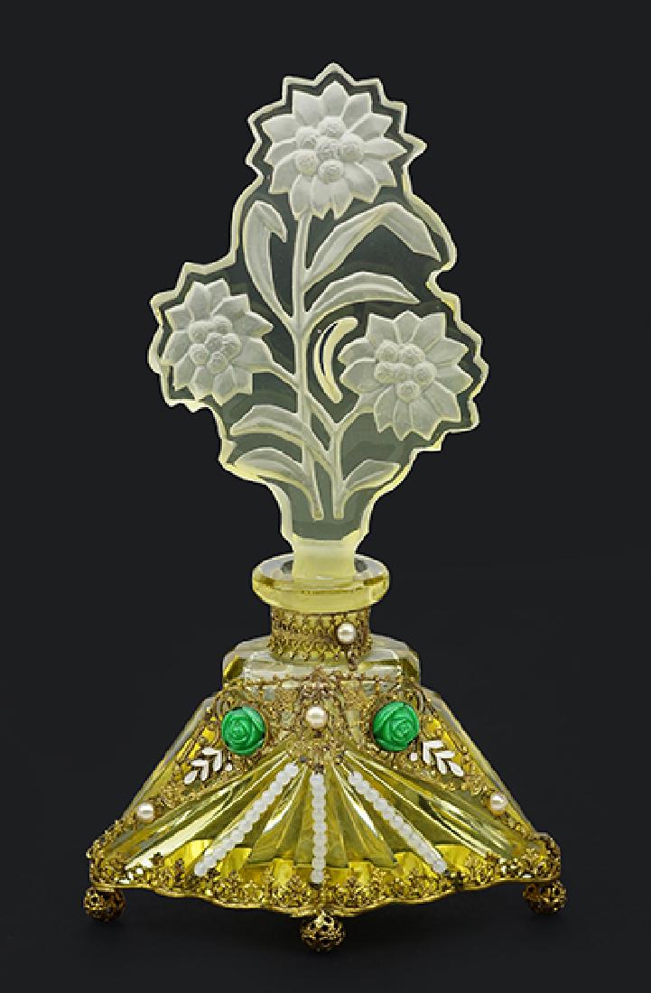 A Czechoslovakian Yellow Crystal Perfume Bottle.: A Czechoslovakian Yellow Crystal Perfume Bottle. Yellow crystal bottle with metalwork gilt jewels and a floral intaglio stopper. Marked Czechoslovakia Height: 6.25"