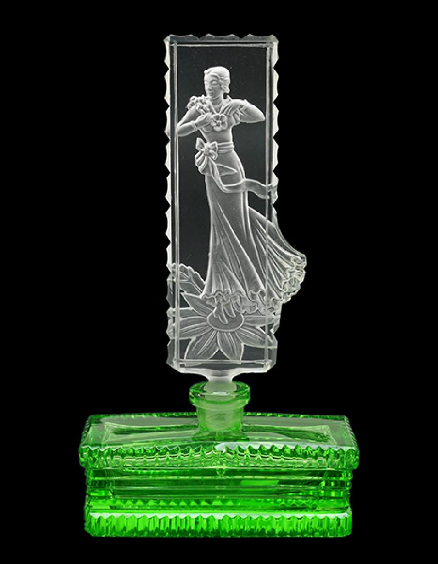 A Czechoslovakian Green Crystal Perfume Bottle.: A Czechoslovakian Green Crystal Perfume Bottle. Green crystal perfume bottle with a clear crystal stopper depicting an art deco intaglio dancing woman. Marked Czechoslovakia Height: 8"