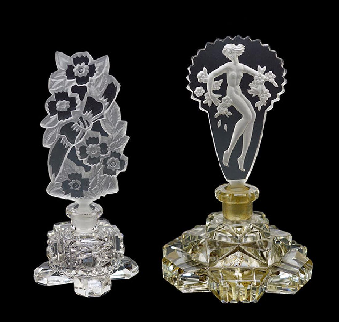 Two Czechoslovakian Crystal Perfume Bottles.: Two Czechoslovakian Crystal Perfume Bottles. Clear crystal perfume bottle with an intaglio stopper of a nude maiden with flowers. Together with a clear crystal perfume bottle with a frosted and clear 