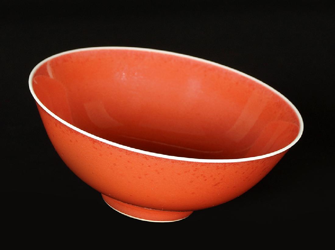 A Chinese Sang de Boeuf Porcelain Bowl.: A Chinese Sang de Boeuf Porcelain Bowl. Bearing an underglaze blue archaic Qianlong mark on the underside. With a wood stand Bowl: 2" x 5"