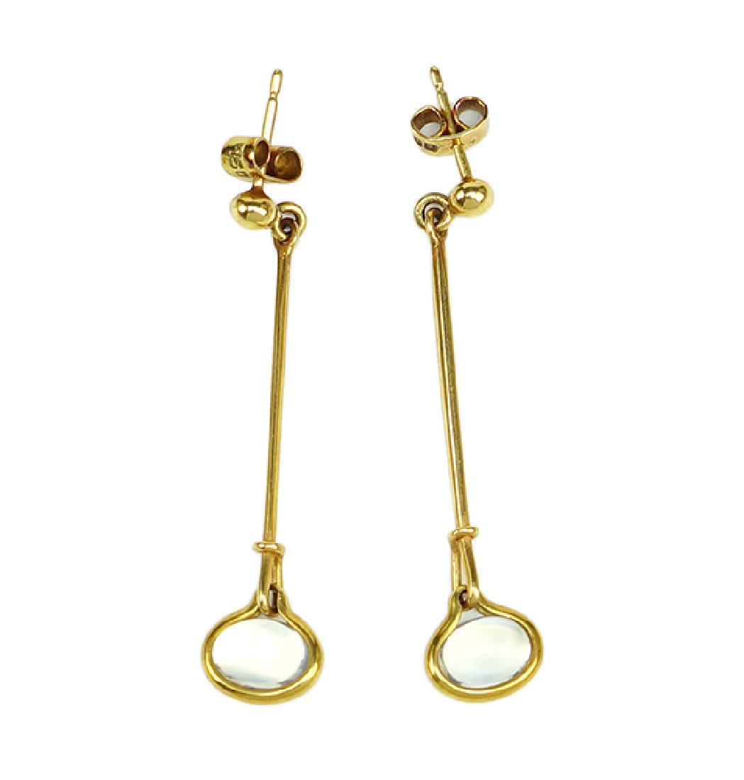 A Pair of Moonstone and 18 Karat Yellow Gold Earrings.: A Pair of Moonstone and 18 Karat Yellow Gold Earrings. Drop post earrings each contain one articulated oval cabochon moonstone. Earring backing in stamped 750. In the style of Torun for Georg Jensen,