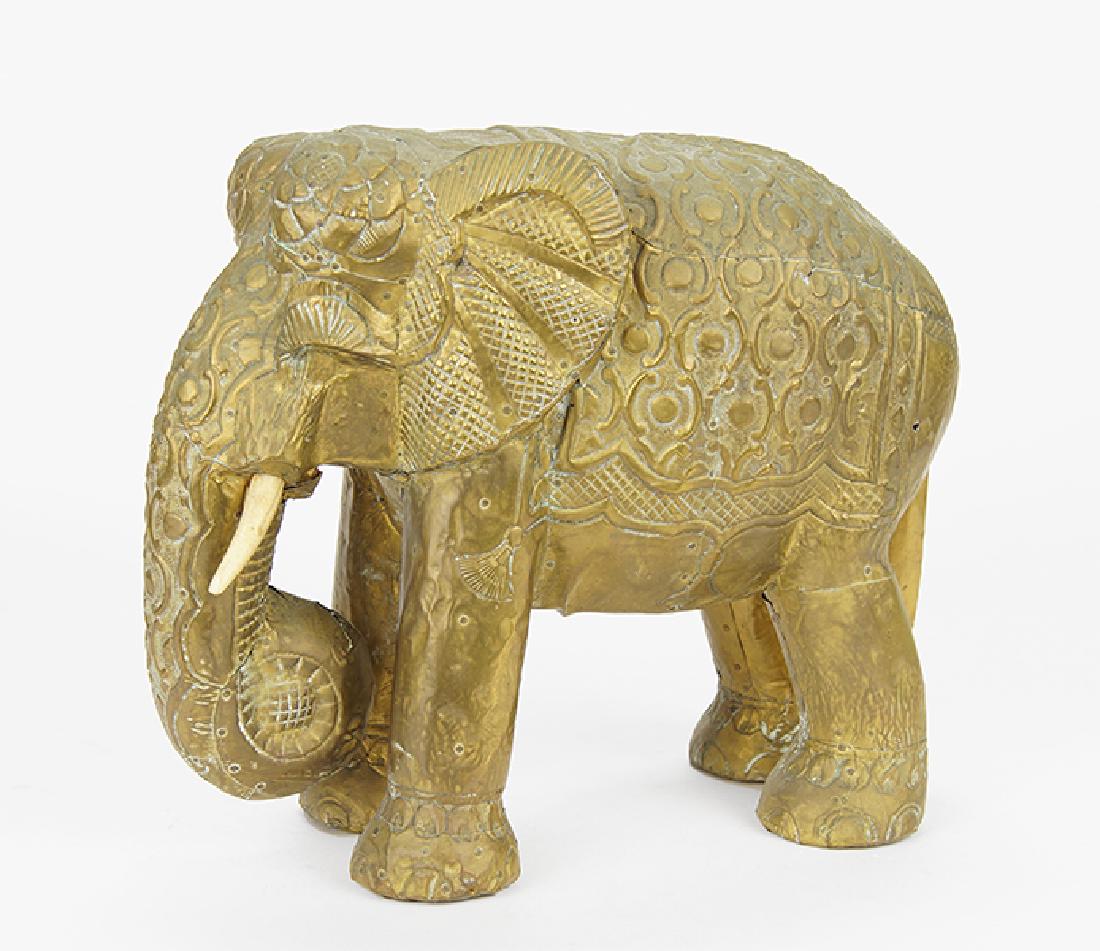 A Southeast Asian Style Elephant Sculpture.: A Southeast Asian Style Elephant Sculpture. Carved wood sculpture with embossed metal overlay and carved bone tusks Overall: 12.5" x 14.5" x 7"