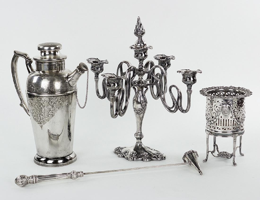 A COllection Of Silverplate Table Articles.: A COllection Of Silverplate Table Articles. Comprising an English silverplate footed wine coaster, an English silverplate cocktail shaker bearing a single letter monogram of "G", a five-light art nouv