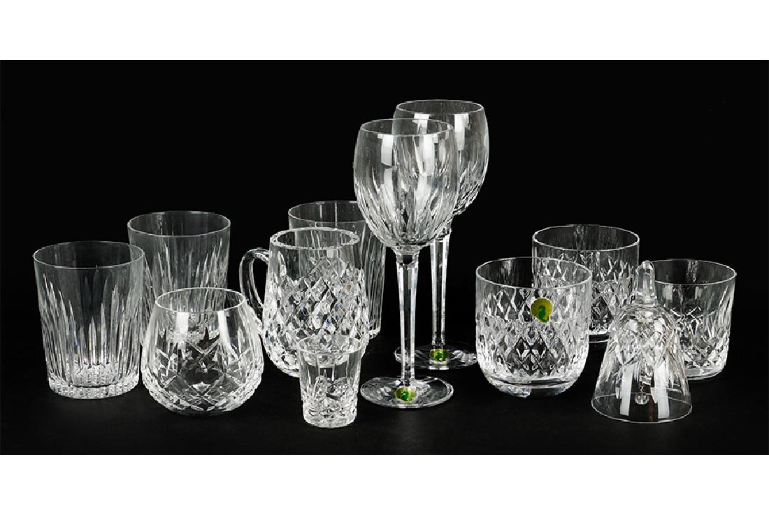 A Collection Of Waterford Crystal.: A Collection Of Waterford Crystal. Comprising an old fashioned glass, a shot glass, a votive, and a bell in the Lismore pattern, two water goblets in the Wynnewood pattern, a mug in the Comeragh patte