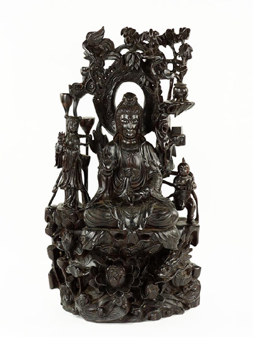 A Chinese Carved Rosewood Figure of a Seated Quan Yin. (1 of 1)