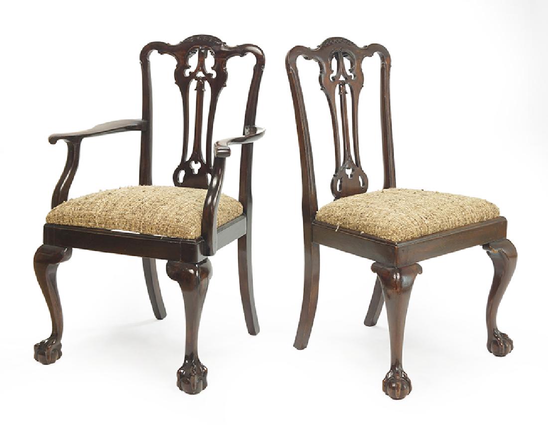 A Set of Eight Dining Chairs.: A Set of Eight Dining Chairs. Comprising two armchairs and six side chairs. Carved mahogany chairs raised on ball and claw feet Side chair back height: 38"