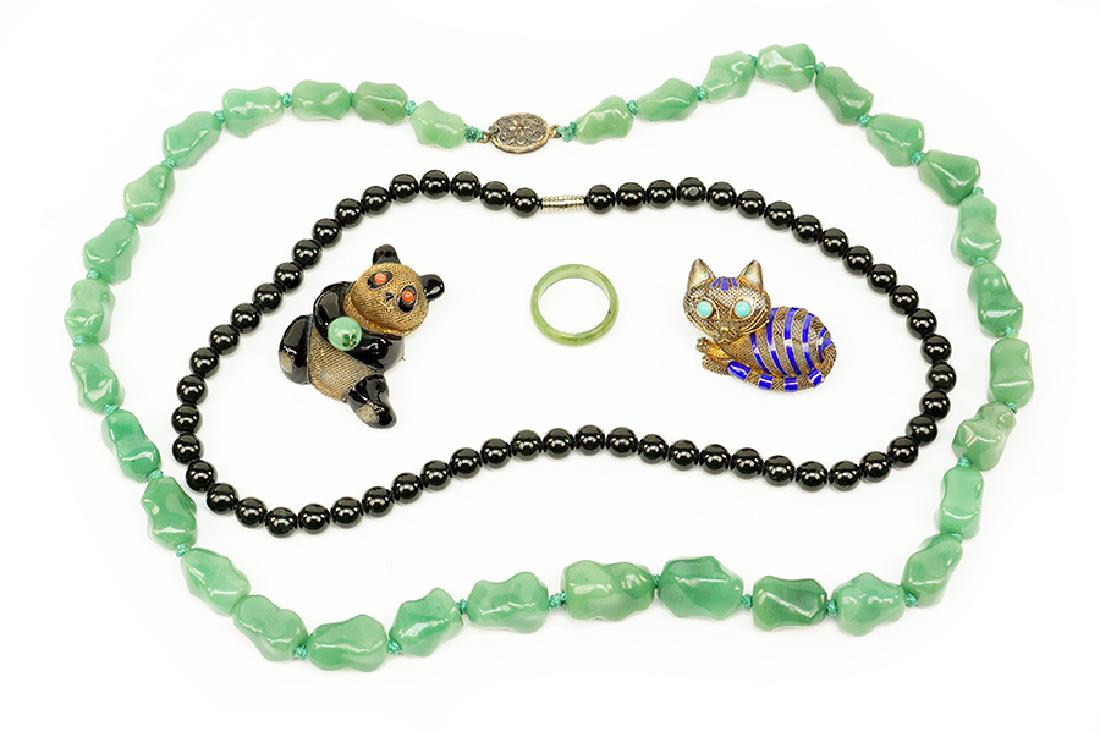 A Green Quartz Bead Necklace.: A Green Quartz Bead Necklace. Together with a black quartz bead necklace, a jade ring, a Chinese silver an enamel panda brooch, and a Chinese silver and enamel cat brooch (1" x 1.5") Green quartz bead