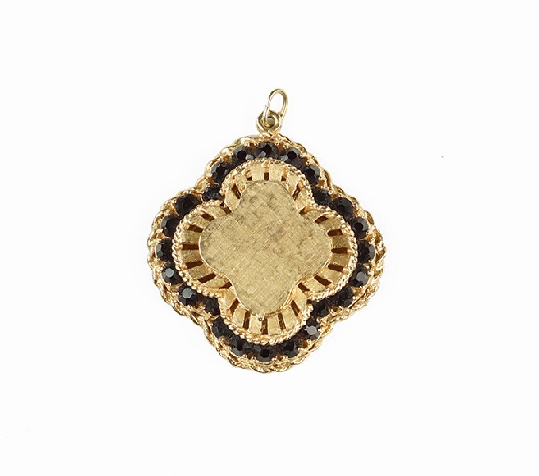 A Garnet Locket Pendant.: A Garnet Locket Pendant. 14 karat yellow gold quatrefoil form pendant contains 24 prong set round garnets 1.5" x 1.5" 17.4 grams