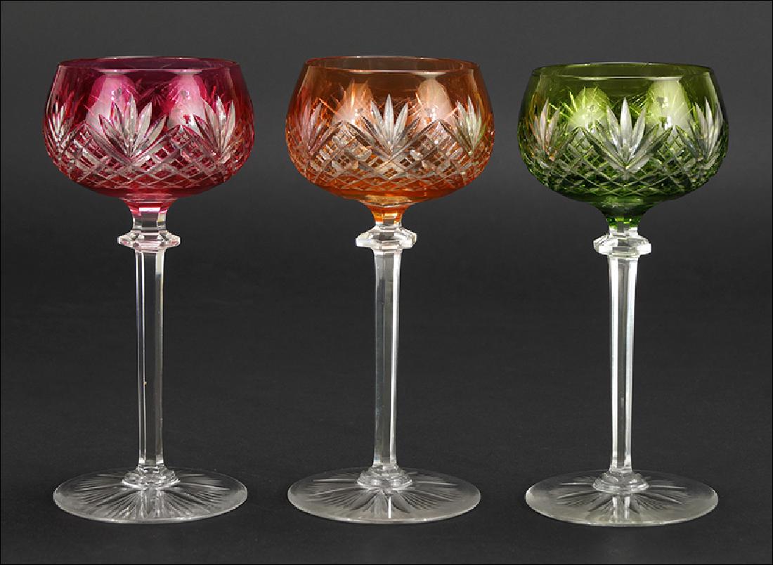 A Set of Twelve German Crystal Wine Goblets.: A Set of Twelve German Crystal Wine Goblets. Cut-to-clear crystal goblets in emerald green, ruby and orange Height: 7"