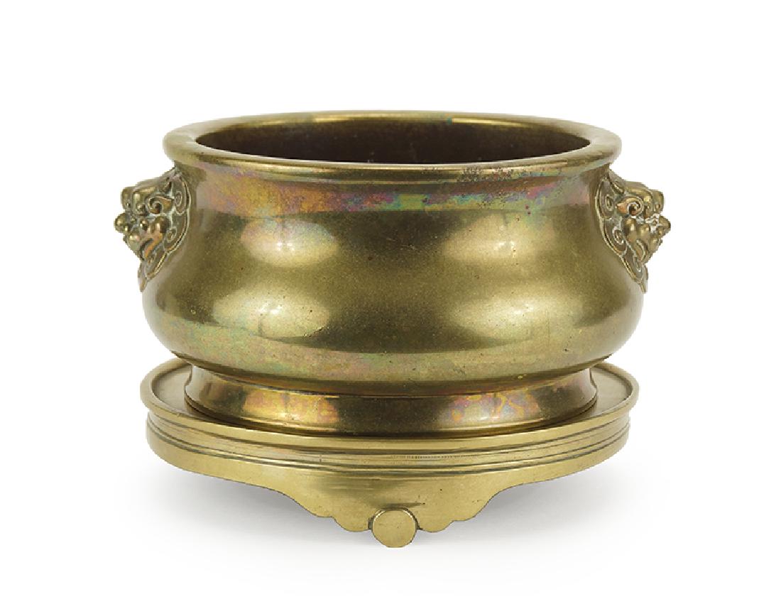 A Chinese Brass Censer and Stand.: A Chinese Brass Censer and Stand. Bearing foo lion form handles and a six-character Ming mark on the underside With stand: 4.5" x 6.25"