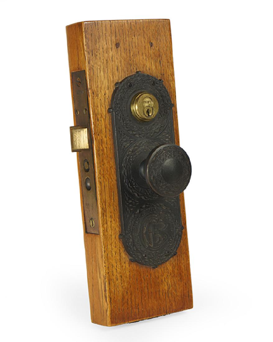 A Sullivan & Adler Chicago Stock Exchange Door Plate.: A Sullivan & Adler Chicago Stock Exchange Door Plate. Cast iron, knob and backplate, mounted to wood Plate: 9.5" x 3.5" Overall: 1.75" x 14.5" x 5"