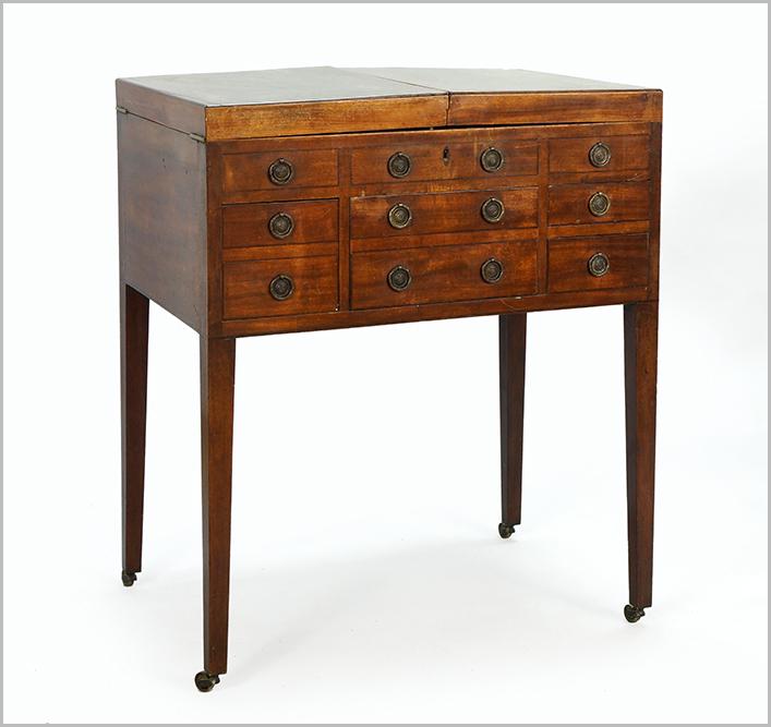 A Regency Beau Brummel Dressing Table.: A Regency Beau Brummel Dressing Table. Mahogany dressing table with flip top that opens to reveal a mirror with adjustable support with fitted compartments on either side 36" x 30" x 20"