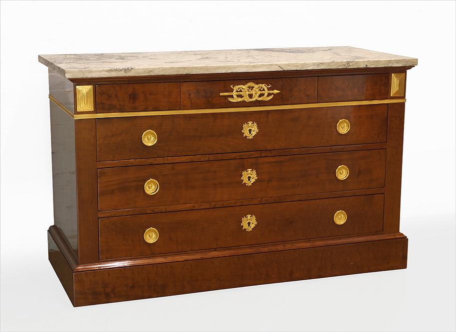 A French Empire Commode.: A French Empire Commode. Early 19th Century French commode is signed on the top left corner "J.A. Bruns" for Jean-Antoine Bruns, circa 1805. Three drawer ormolu mounted mahogany chest with a marble to