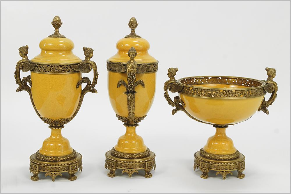 A French Style Garniture Set.: A French Style Garniture Set. A pair of crackle glazed porcelain covered urns and a center bowl, bearing winged figural handles Urn height: 26"