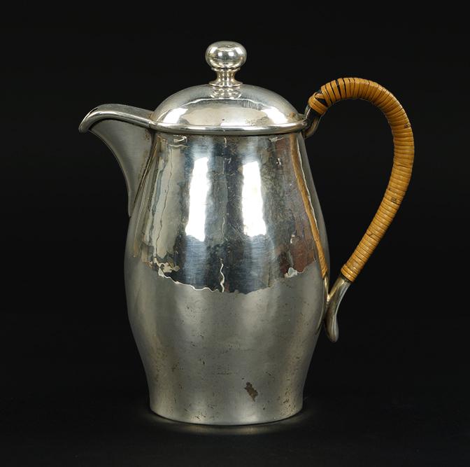 A Porter Blanchard Coffee Pot.: A Porter Blanchard Coffee Pot. Hand hammered coffee pot with a rattan handle. Underside is stamped "Porter Blanchard Sterling Handmade" Height: 8" Wt: 18.10 ozt