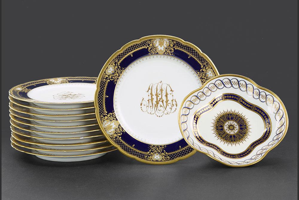 A Set of Eleven Dresden Gilt Cobalt Porcelain Plates.: A Set of Eleven Dresden Gilt Cobalt Porcelain Plates. Each bearing a gilt three letter script monogram at center. Together with a Copeland Spode porcelain dish (2" x 8" x 8.75") Plate diameter: 10"
