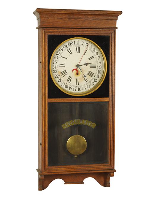 8-Day Regulator and Calendar Clock.: 8-Day Regulator and Calendar Clock. Featuring a wall mounted clock with an 8-day regulator and calendar dial. The dial is marked USA. Susanin's will not comment on the working condition of any watch o