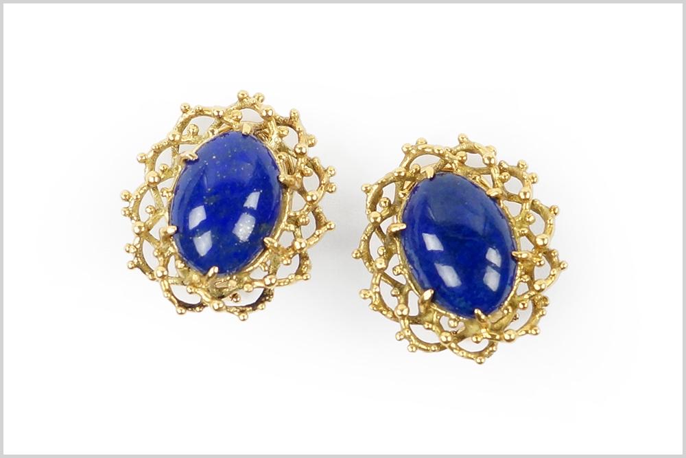 A Pair of Lapis Earclips.: A Pair of Lapis Earclips. 14 karat yellow gold mountings each contain one prong set oval lapis cabochon. Omega clip backing Wt: 8.8 grams