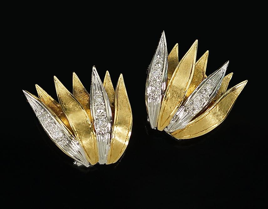 A Pair of Diamond Earclips.: A Pair of Diamond Earclips. 18 karat yellow and white gold mountings each contain six bead set round brilliant diamonds. Omega clip backs .75" x .75" Wt: 10.8 grams