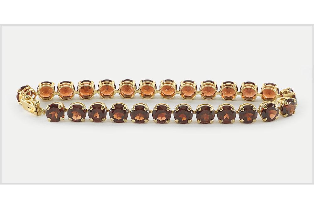 A Garnet Line Bracelet.: A Garnet Line Bracelet. 14 karat yellow gold line bracelet contains 26 prong set round garnets Length: 7" Wt: 11.8 grams